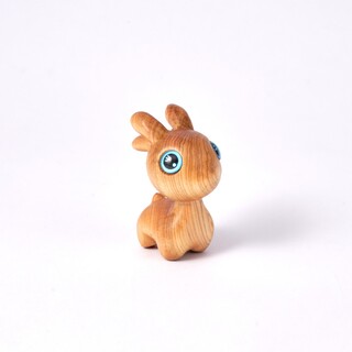 Dari Carved Wooden Deer Standing in the Forest