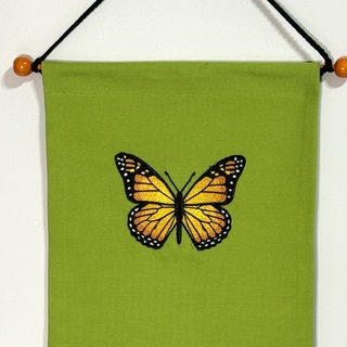 Butterfly on green pin banner